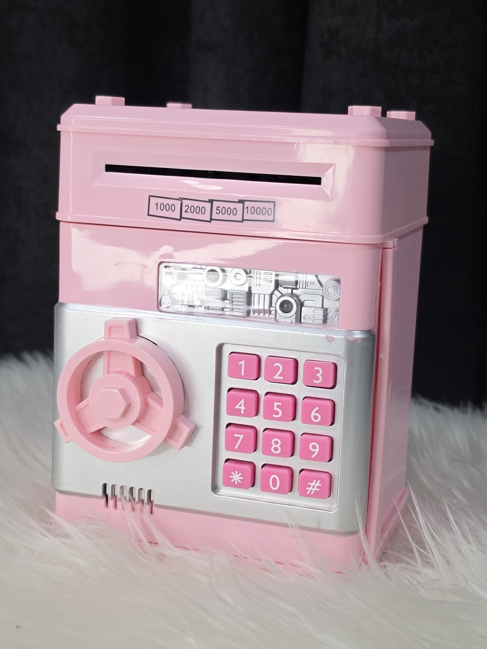 pink electronic mini ATM piggy bank with a password keypad and a safe-style door